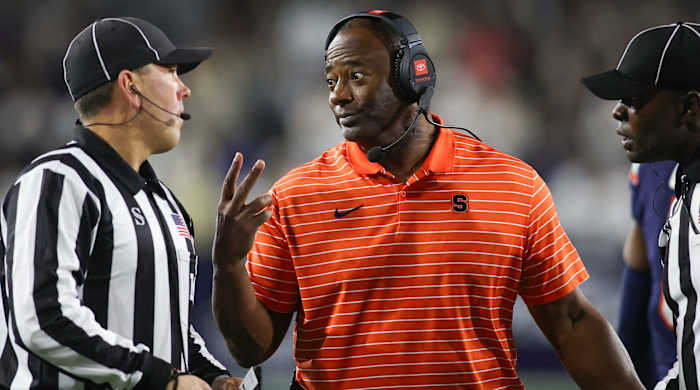 Syracuse football coach Dino Babers talks to a referee during a game against Georgia Tech.
